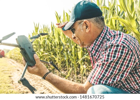 modern technological farmer as he prepares to fly the drone over his cultivated fields. concept of sustainable exploitation of natural resources.