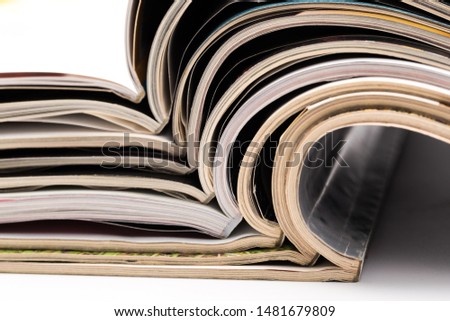 selective focus of the stacking magazine place on white background. Colorful abstract background