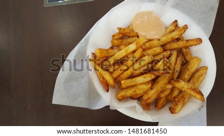 A plate full of french fries with Indian spices called masala. Royalty-Free Stock Photo #1481681450