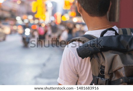 Back side of Young Asian traveling men walking and looking in china town walking street in evening at Bangkok, Thailand, traveler and tourist concept