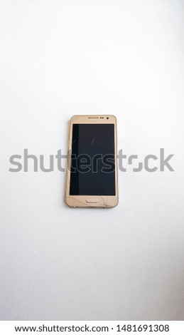 broken mobile phone on a blue wooden background. Repair of mobile phone