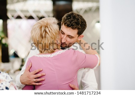 Mom congratulates the groom with a marriage and hugs. woman welcomes. Happy groom. Wedding ceremony. Close up Royalty-Free Stock Photo #1481717234