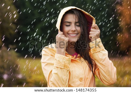 Natural female beauty in autumn rain Royalty-Free Stock Photo #148174355