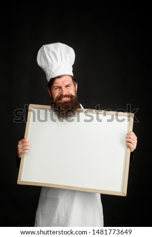 Chef menu. Empty menu chalkboard with copy space for text. Cooking, culinary, diet, advertisement and food concept. Master chef, baker or cook shows menu sign blackboard. Professional chef on kitchen.