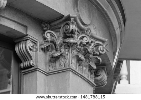 Elements of architectural decorations of buildings, columns and capitals, gypsum moldings, wall textures and patterns. On the streets in Georgia, public places. Black and white retro style photo.