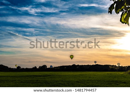 A wallpaper picture with balloons and clouds 