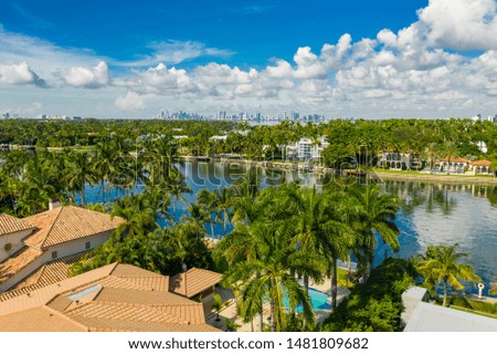 Upscale homes in Miami Beach waterfront with palm trees