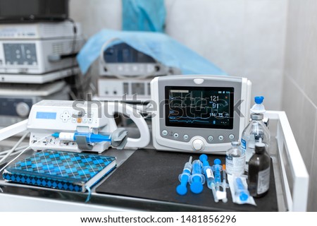 Cardiac monitor and syringe at operating table. Pet surgery. Royalty-Free Stock Photo #1481856296