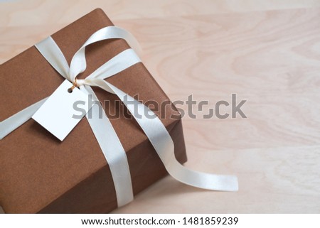 Gift Box on wood table with blank card, copy space