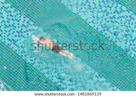 High angle view of a man swimming in a swimming pool