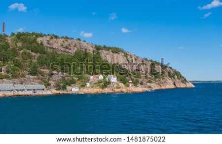 Beautiful seascape norwegian coastline, coast of Kristiansand with small lighthouse, Scandinavia, Norway. July 2019