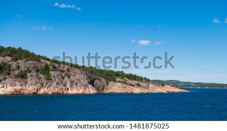 Beautiful seascape norwegian coastline, coast of Kristiansand with small lighthouse, Scandinavia, Norway. July 2019