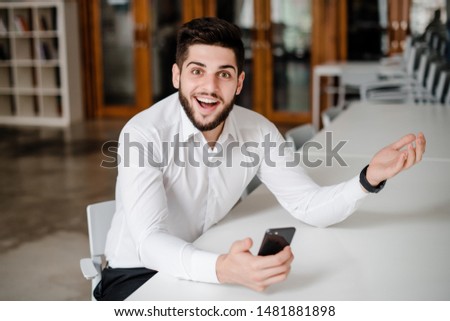 handsome man at workplace with phone