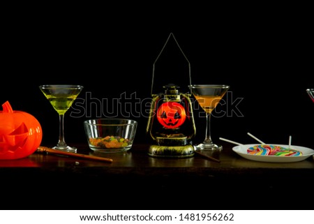 Halloween party. Halloween pumpkin, candies and colored cocktails on the table for a Halloween party 