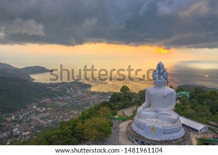 aerial photography the thunderstorm around Phuket big Buddha  statue in sunset time.