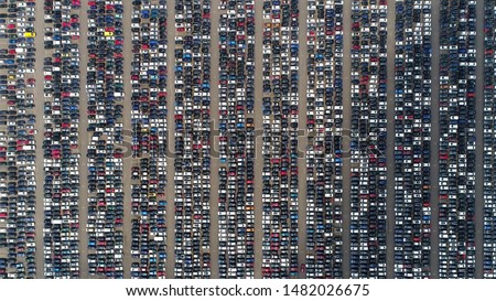 Aerial top down view of automaker distribution center with new vehicles perfectly lined up next to each other ready for further transportation retailers and dealerships Royalty-Free Stock Photo #1482026675