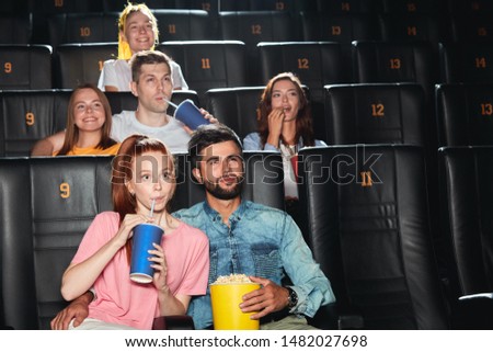 young attractive people having pleasant time at the cinema, close up photo. friendship concept