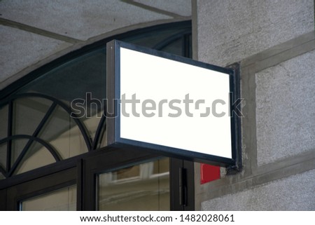Signboard shop or restaurant. Mock up. Rectangular shape and Horizontal side view of empty color signage on business skyscraper with modern architecture and glass windows