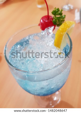 Blue Hawaii that is decorated with cherries and lemon