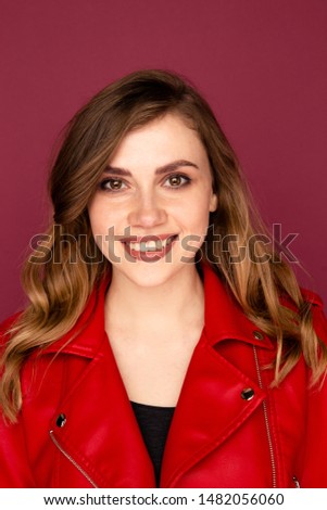 Closeup portrait of handsome young girl smiling on the camera in a studio.