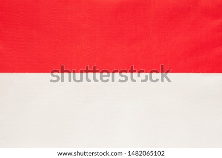 Monaco national fabric flag, textile background. Symbol of international world european country. State official sign.