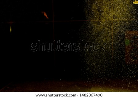 Abstract green blurred dust explosion on a black background