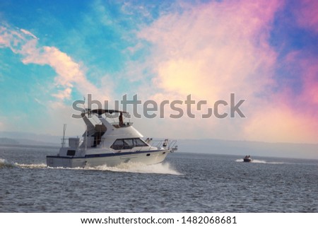 Luxury motor boat. Pink clouds in the sky
