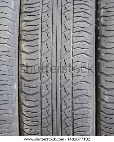 The background of the tread pattern of the car wheel. Rubber tires.