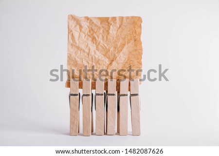 Woodenl clothespins, paper clip and brown sticker on white background. Isolated on white. Place for your text