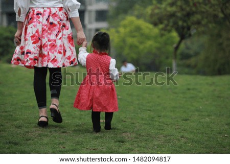 mom and daughter hand in hand