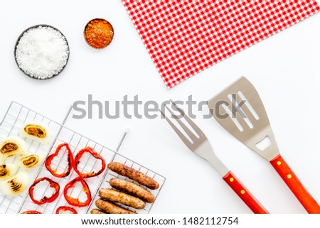 barbecue, sausages, vegetables on white background top view