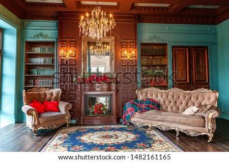 Luxury classic interior of home library. Sitting room with bookshelf, books, arm chair, sofa and fireplace. Clean and modern decoration with elegant furniture. Education read study wisdom concept Royalty-Free Stock Photo #1482161165