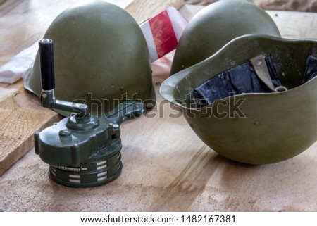 Russian military helmet on a wooden background. The classic form of a helmet to protect the head from splinters.