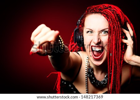 Expressive girl rock singer with great red dreadlocks.