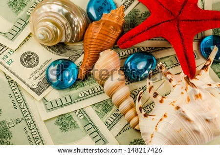 Shells starfish and water drops on dollars