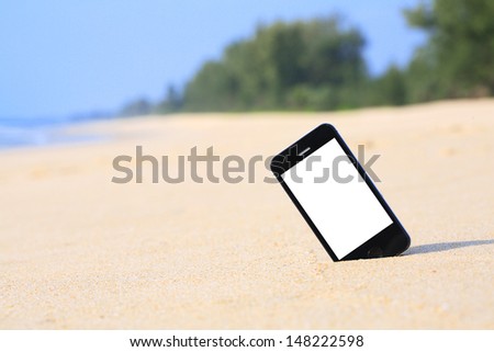 smartphone on the beach. Royalty-Free Stock Photo #148222598