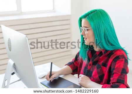 Illustrator, graphic designer, animator and artist concept - creator woman with beautiful green hair and glasses drawing in laptop