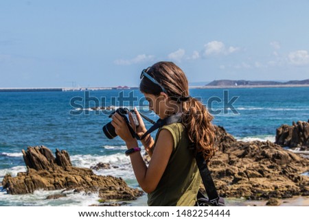 young girl taking photo with reflex camera