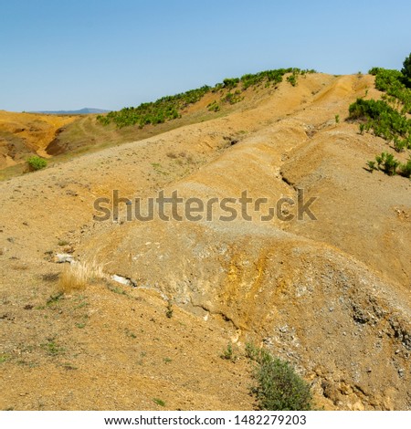 Albanian nature landscape. Sandy hills with rainwater sign on the ground