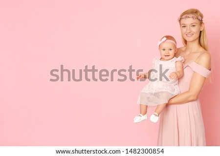 Beautiful portrait of young mom and her little, cute daughter. The picture full of love.