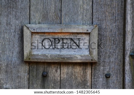 Wooden sign with Open written upon it