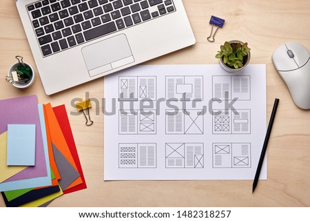 Editorial design. Graphic designer desk with magazine layout designs. Flat lay Royalty-Free Stock Photo #1482318257