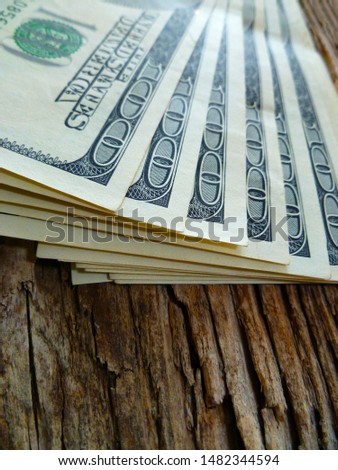 Pile of one hundred dollar bills close-up. Close up heap of one hundred dollars, selective focus. Dollars, us money, cash background. Dollar (USD) banknotes, currency of United States (USA).