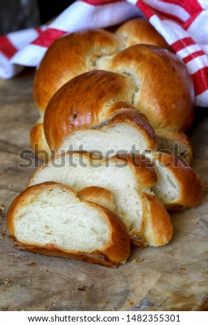 Fresh homemade challah bread. wooden background - vertical image