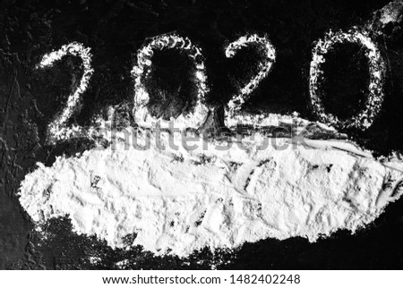 New year 2020. Numbers on black background. Snowy mood. Festive concept.