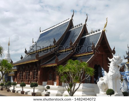 Thai wood temple with cloudy sky