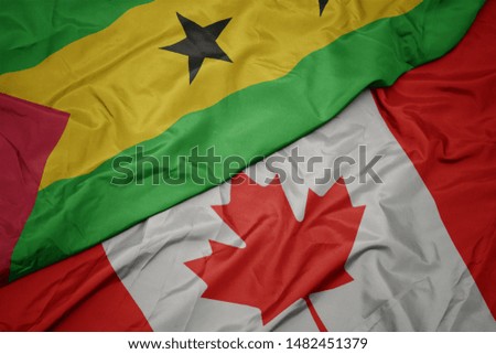 waving colorful flag of canada and national flag of sao tome and principe. macro