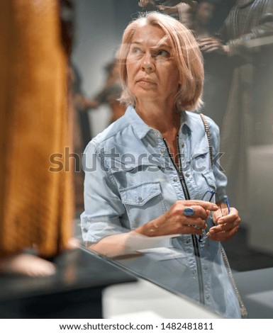 woman visitor looking art object in art gallery museum