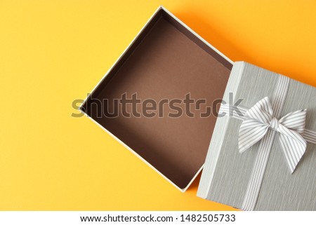 Open gift box on a colored background top view.

