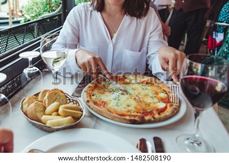 crop picture of woman in restaurant eating pizza drinking wine outdoors cafe